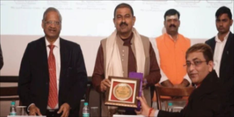 Receiving a commemorative plaque on stage